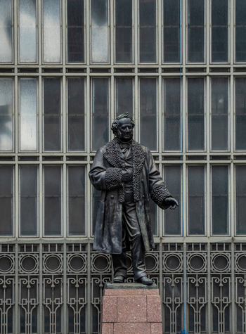 View of the Cornelius Vanderbilt statue standing in front of the glass facade of Grand Central Terminal New York New York United States. View of the Cornelius Vanderbilt statue standing in front of the glass facade of Grand Central Terminal New York New York United States.