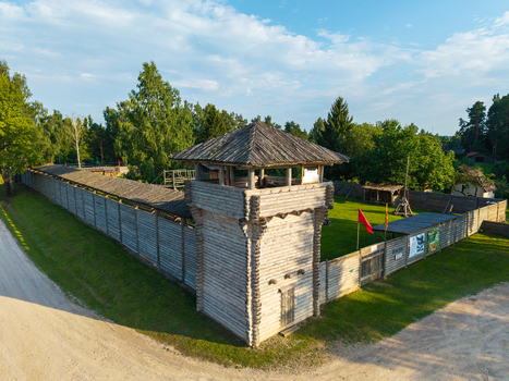 Aerial view of Voruta castle a wooden fortress reconstruction with a central tower defensive walls and a grassy courtyard surrounded by trees in Anyksciai Utenos apskritis Lithuania.