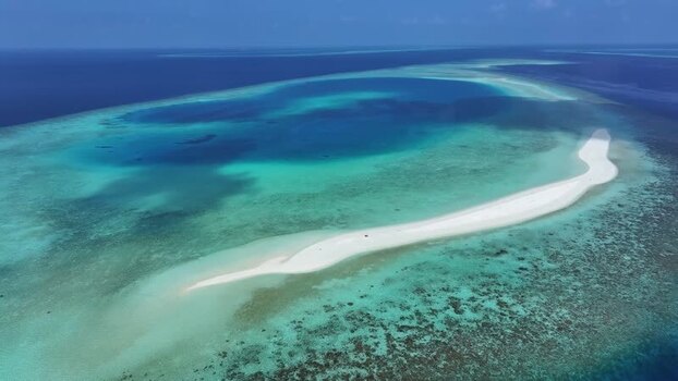 Aerial view of a white sandbank and coral reefs in Kendhoo Maldives. Aerial view of a white sandbank and coral reefs in Kendhoo Maldives.