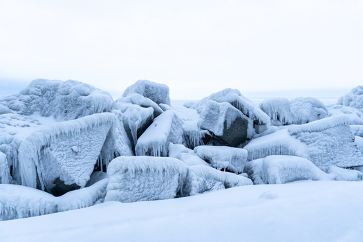View of ice covered rocks and breakwater blocks along the coast in Sassnitz Mecklenburg Vorpommern Germany.