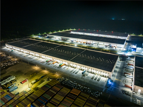 Aerial view of Caucedo Logistics Center at night with illuminated warehouse facilities shipping containers and loading docks in Andres Santo Domingo Dominican Republic. Aerial view of Caucedo Logistics Center at night with illuminated warehouse facilities shipping containers and loading docks in Andres Santo Domingo Dominican Republic.