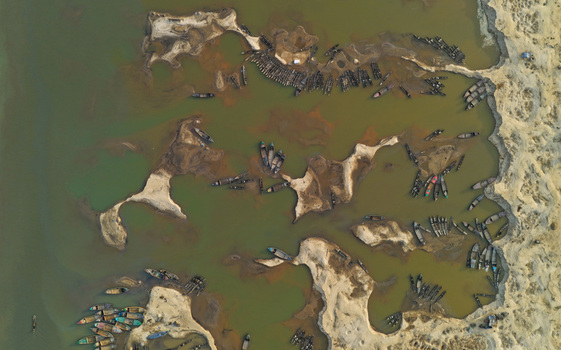 Aerial view of Jadukata River with numerous wooden boats moored along the sandbanks in the river Sunamganj Sylhet Division Bangladesh. Aerial view of Jadukata River with numerous wooden boats moored along the sandbanks in the river Sunamganj Sylhet Division Bangladesh.