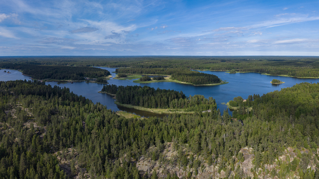 Aerial view of the lush green forests and islands scattered across the blue waters of the bay in Mantlahti Kymenlaakso Finland.