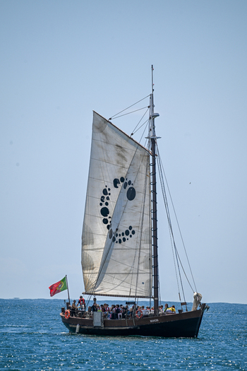 Cascais e Estoril Portugal 13 May 2026 View of a traditional wooden sailing boat with passengers navigating the calm blue waters of the Atlantic Ocean under a clear sky.