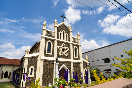 View of St. Mary s Church with its stone walls and white architectural details under a bright blue sky in Matara Southern Province Sri Lanka.