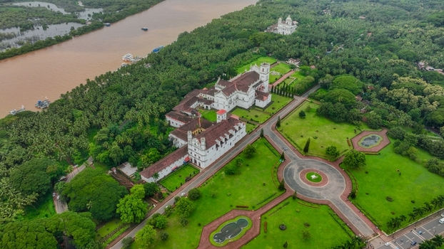Aerial view of Church of St. Francis of Assisi surrounded by lush greenery manicured lawns and the Mandovi River in Old Goa Goa India. Aerial view of Church of St. Francis of Assisi surrounded by lush greenery manicured lawns and the Mandovi River in Old Goa Goa India.