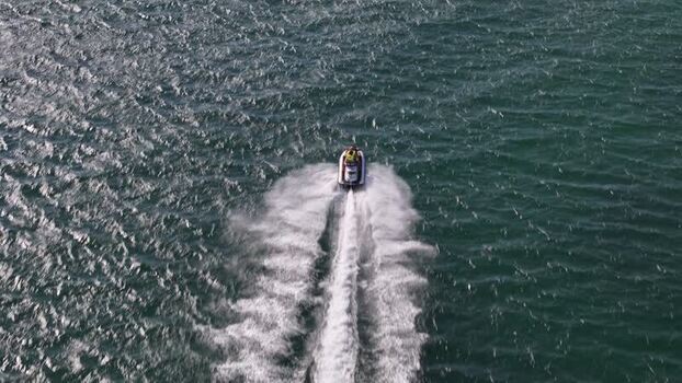 Aerial view of a jet ski speeding across the ocean Portugal.