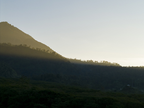 Aerial view of Bunker Kaliadem Merapi area with golden sunlight hitting the mountain ridge and dense forest below Kecamatan Pakem Daerah Istimewa Yogya Indonesia. Aerial view of Bunker Kaliadem Merapi area with golden sunlight hitting the mountain ridge and dense forest below Kecamatan Pakem Daerah Istimewa Yogya Indonesia.
