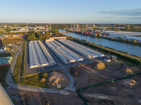 Aerial view of the Cargovil battery energy storage system featuring rows of battery containers situated along an industrial canal in Vilvoorde Vlaanderen Belgium. Aerial view of the Cargovil battery energy storage system featuring rows of battery containers situated along an industrial canal in Vilvoorde Vlaanderen Belgium.