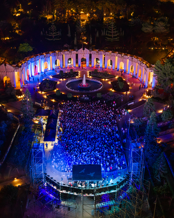 Attard Malta 20 September 2026 Aerial view of Park Nazzjonali Ta Qali illuminated at night with a large crowd gathered for an outdoor concert in front of a stage and a central fountain. Attard Malta 20 September 2026 Aerial view of Park Nazzjonali Ta Qali illuminated at night with a large crowd gathered for an outdoor concert in front of a stage and a central fountain.