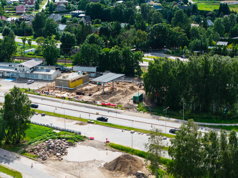 Aerial view of a new gas station under construction with fuel pumps and service building surrounded by trees and roads in Riga Latvia. Aerial view of a new gas station under construction with fuel pumps and service building surrounded by trees and roads in Riga Latvia.