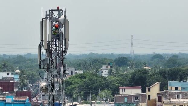 Aerial view of a technician working on a cell tower Bangladesh.
