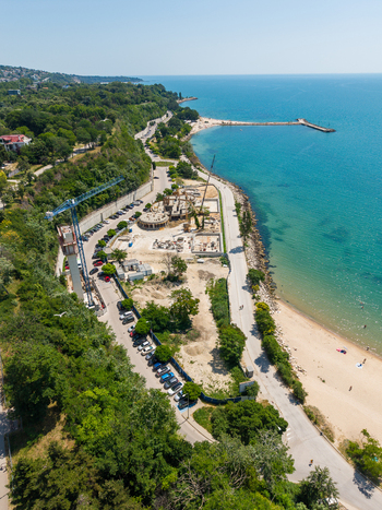 Aerial view of the construction site along Alley First promenade featuring a crane parked cars and the Black Sea coastline in Varna Varna Bulgaria. Aerial view of the construction site along Alley First promenade featuring a crane parked cars and the Black Sea coastline in Varna Varna Bulgaria.