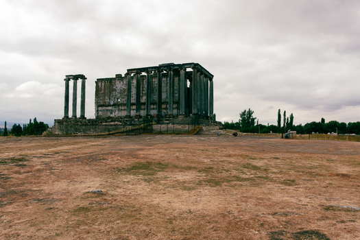 View of the ancient Temple of Aizonai with its towering columns and weathered stone walls under a cloudy sky in Cavdarhisar Kutahya Turkiye. View of the ancient Temple of Aizonai with its towering columns and weathered stone walls under a cloudy sky in Cavdarhisar Kutahya Turkiye.