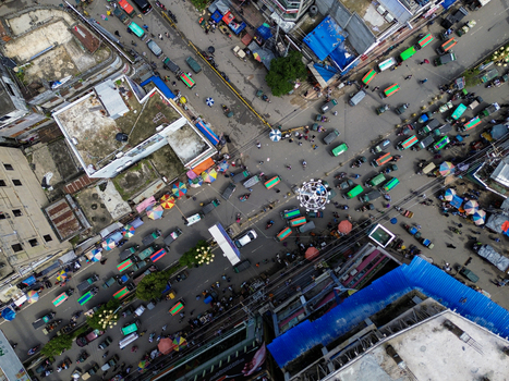 Rajshahi Bangladesh 26 September 2026 Aerial view of a busy street intersection in Rajshahi with numerous vehicles colorful umbrellas and pedestrians navigating the urban area. Rajshahi Bangladesh 26 September 2026 Aerial view of a busy street intersection in Rajshahi with numerous vehicles colorful umbrellas and pedestrians navigating the urban area.