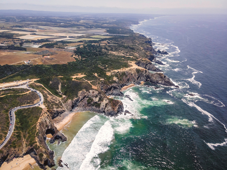 Aerial view of beautiful wild cliff coastline near Odeceixe Faro Portugal.