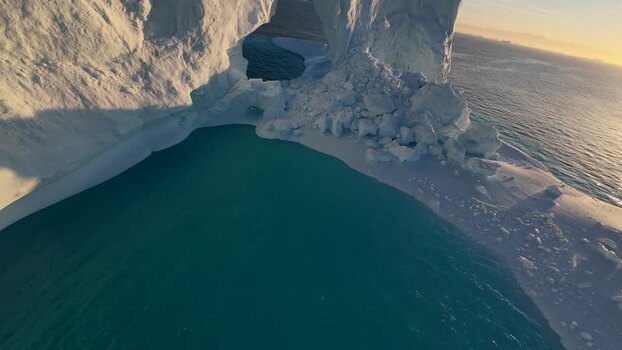 FPV aerial view of arch iceberg in Greenland. FPV aerial view of arch iceberg in Greenland.
