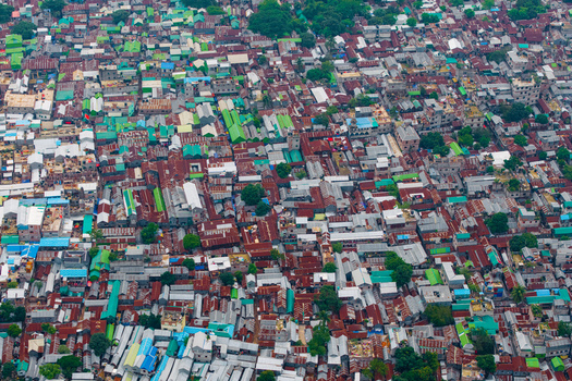 Dhaka Bangladesh 19 June 2026 Aerial view of the dense urban landscape with colorful rooftops narrow streets and scattered trees in the city of Dhaka.
