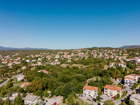 Aerial view of residential houses surrounded by lush greenery and trees in the village of Marcelji Primorje Gorski Kotar Croatia.
