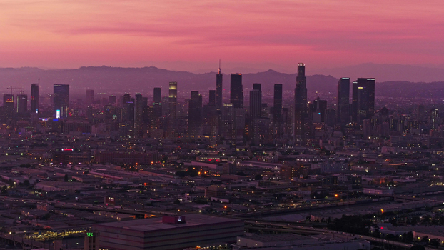 Aerial view of the Los Angeles skyline at sunset with pink sky skyscrapers and urban infrastructure Los Angeles California United States.