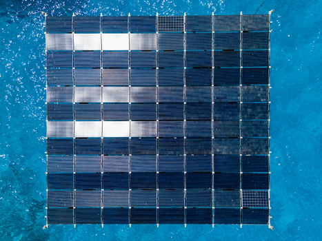 Aerial view of SolarSea floating solar power plant by Swimsol with dark panels reflecting light on turquoise water Dharavandhoo Baa Atoll Maldives. Aerial view of SolarSea floating solar power plant by Swimsol with dark panels reflecting light on turquoise water Dharavandhoo Baa Atoll Maldives.