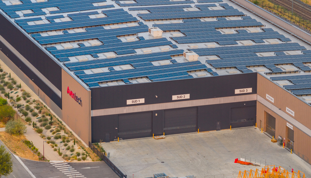 Alixan Auvergne Rhone Alpes France 25 July 2026 Aerial view of the Aventech industrial warehouse in the Rovaltain technology park featuring a large rooftop solar array.
