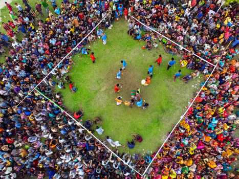 Nilphamari Bangladesh 01 May 2026 Aerial view of a large crowd of people gathered around a square grassy arena for a traditional event with musicians and participants. Nilphamari Bangladesh 01 May 2026 Aerial view of a large crowd of people gathered around a square grassy arena for a traditional event with musicians and participants.