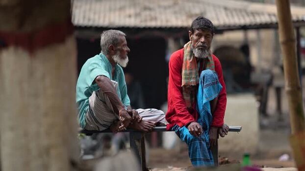 View of two elderly men sitting in a village Bangladesh.