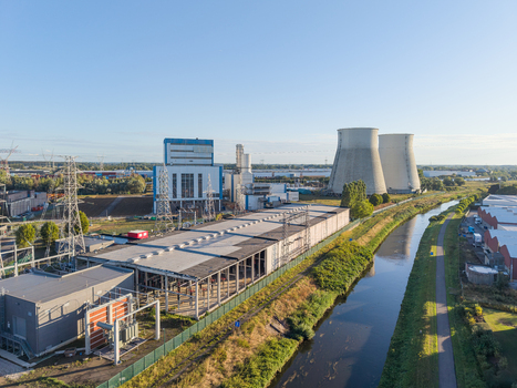 Aerial view of the Cargovil industrial site featuring cooling towers power infrastructure and a battery energy storage system along a canal in Vilvoorde Vlaanderen Belgium. Aerial view of the Cargovil industrial site featuring cooling towers power infrastructure and a battery energy storage system along a canal in Vilvoorde Vlaanderen Belgium.