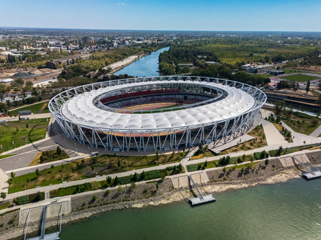 Budapest Hungary 31 August 2026 Aerial view of National Athletics Center by the Danube River featuring the modern stadium exterior roof structure and urban waterfront in Ferencvaros. Budapest Hungary 31 August 2026 Aerial view of National Athletics Center by the Danube River featuring the modern stadium exterior roof structure and urban waterfront in Ferencvaros.