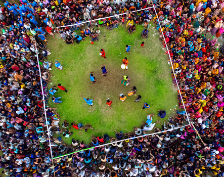 Nilphamari Bangladesh 01 May 2026 Aerial view of a traditional folk game performance with a large crowd of people surrounding a square grassy field during a local festival. Nilphamari Bangladesh 01 May 2026 Aerial view of a traditional folk game performance with a large crowd of people surrounding a square grassy field during a local festival.