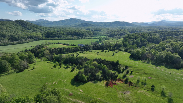 Aerial view of the rolling green hills and lush forests of the countryside in Amherst County Virginia United States.
