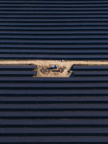 Aerial view of a vast solar farm with endless rows of photovoltaic panels and a central maintenance station in Uckermark Brandenburg Germany. Aerial view of a vast solar farm with endless rows of photovoltaic panels and a central maintenance station in Uckermark Brandenburg Germany.