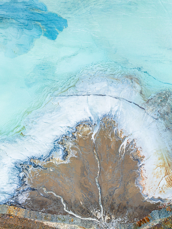 Aerial view of a mineral rich river delta with turquoise water flowing into sediment deposits creating intricate patterns across the landscape in Andalusia Spain. Aerial view of a mineral rich river delta with turquoise water flowing into sediment deposits creating intricate patterns across the landscape in Andalusia Spain.