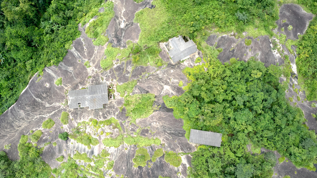 Aerial view of Idanre Hill featuring ancient stone structures nestled on rocky terrain surrounded by lush tropical vegetation in Idanre Ondo State Nigeria. Aerial view of Idanre Hill featuring ancient stone structures nestled on rocky terrain surrounded by lush tropical vegetation in Idanre Ondo State Nigeria.