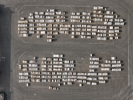 Aerial view of a storage yard with rows of stacked white pallets or construction materials on an asphalt surface in Dulmen North Rhine Westphalia Germany. Aerial view of a storage yard with rows of stacked white pallets or construction materials on an asphalt surface in Dulmen North Rhine Westphalia Germany.