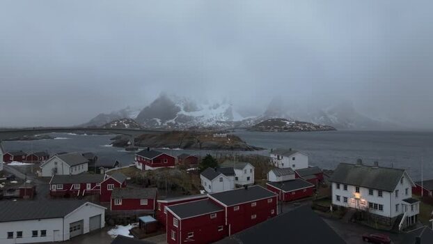 Aerial view of Lofoten with red houses and snowy mountains Norway.