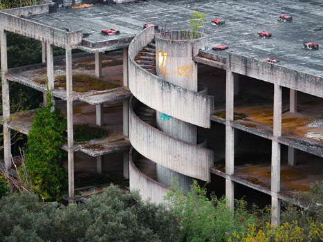 Aerial view of an abandoned multi story concrete building featuring a prominent spiral staircase with graffiti and overgrown vegetation Leccio Toscana Italy. Aerial view of an abandoned multi story concrete building featuring a prominent spiral staircase with graffiti and overgrown vegetation Leccio Toscana Italy.