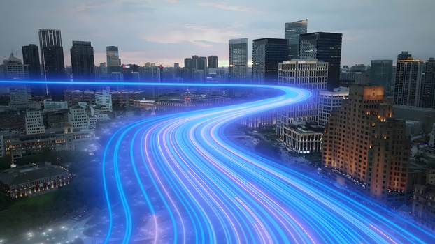 Aerial view of the Shanghai skyline at dusk featuring vibrant blue light trails flowing through the urban landscape with modern skyscrapers and historic architecture in Shanghai Shanghai China.
