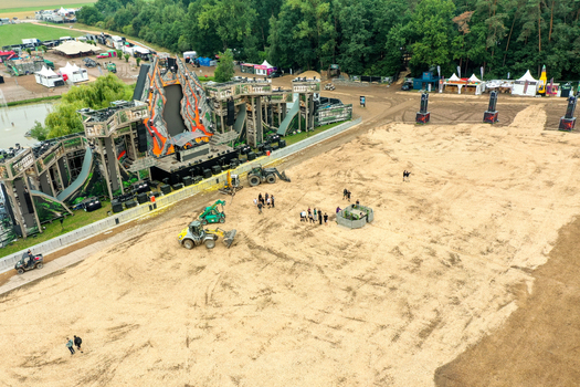 Herzogenaurach Germany 27 July 2025 Aerial view of the Open Beatz Festival main stage under construction with workers on a sandy ground and surrounding forest. Herzogenaurach Germany 27 July 2025 Aerial view of the Open Beatz Festival main stage under construction with workers on a sandy ground and surrounding forest.