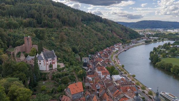 Aerial view of Burg Miltenberg overlooking the historic town of Miltenberg the Main River and surrounding forested hills in Miltenberg Bayern Germany. Aerial view of Burg Miltenberg overlooking the historic town of Miltenberg the Main River and surrounding forested hills in Miltenberg Bayern Germany.