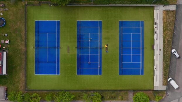 Aerial view of blue tennis courts in Otnice Czechia. Aerial view of blue tennis courts in Otnice Czechia.