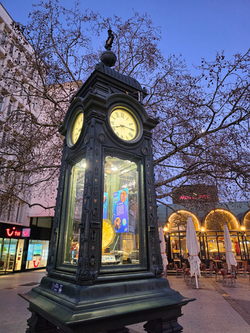 Hanover Germany 30 March 2026 View of the historic Kropcke Clock standing in the city center with illuminated clock faces and intricate metalwork against a twilight sky.