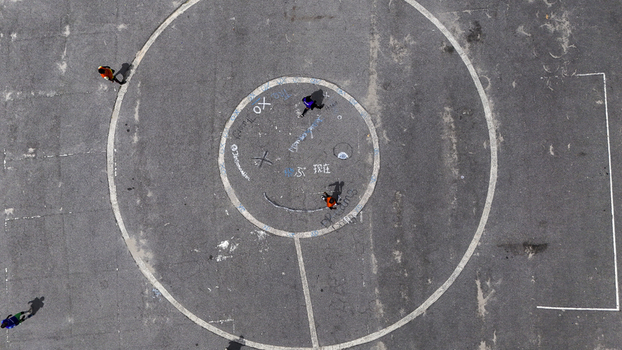 Aerial view of people walking across the asphalt court with white painted circles at National Stadium Surulere Lagos Lagos Nigeria. Aerial view of people walking across the asphalt court with white painted circles at National Stadium Surulere Lagos Lagos Nigeria.