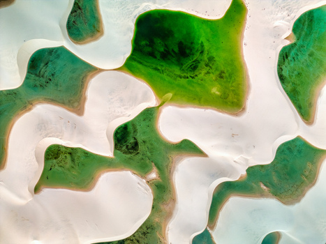 Aerial view of Lagoa Bonita featuring vibrant green lagoons nestled among vast white sand dunes in the Lencois Maranhenses National Park Barreirinhas State of Maranhao Brazil. Aerial view of Lagoa Bonita featuring vibrant green lagoons nestled among vast white sand dunes in the Lencois Maranhenses National Park Barreirinhas State of Maranhao Brazil.
