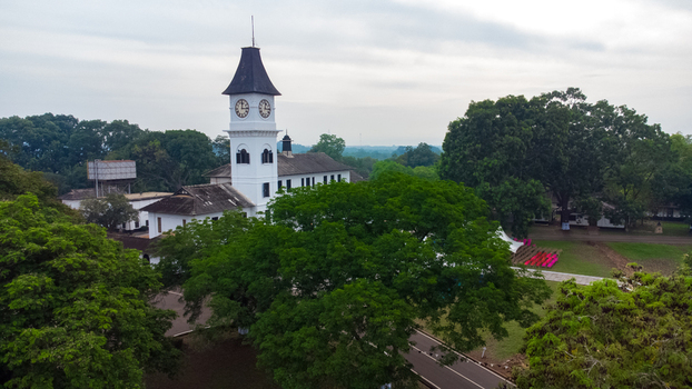 Aerial view of the historic Achimota School clock tower surrounded by lush green trees and campus grounds in Achimota Greater Accra Region Ghana. Aerial view of the historic Achimota School clock tower surrounded by lush green trees and campus grounds in Achimota Greater Accra Region Ghana.