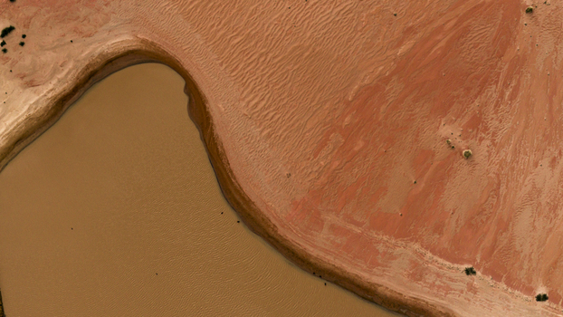 Aerial view of the textured landscape showing the contrast between a body of water and sandy terrain highlighting natural patterns in Kalbarri Western Australia Australia. Aerial view of the textured landscape showing the contrast between a body of water and sandy terrain highlighting natural patterns in Kalbarri Western Australia Australia.