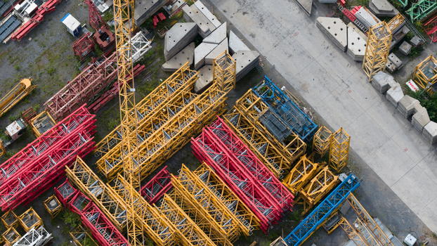 Aerial view of colorful crane components and lattice booms stored at Feluy de Parc Industriel in an industrial area Seneffe Region wallonne Belgium.