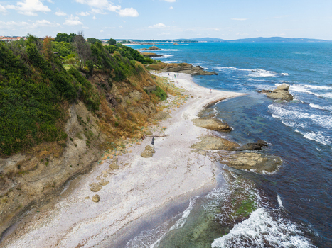 Aerial view of The Clam Beach featuring rocky cliffs sandy shoreline and turquoise sea waters in Lozenets Burgas Bulgaria. Aerial view of The Clam Beach featuring rocky cliffs sandy shoreline and turquoise sea waters in Lozenets Burgas Bulgaria.