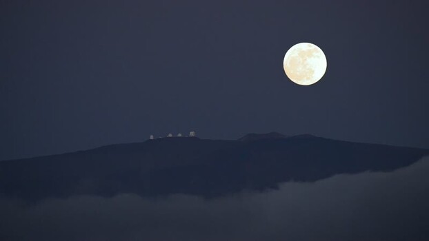 View of observatories on a mountain under a full moon United States. View of observatories on a mountain under a full moon United States.